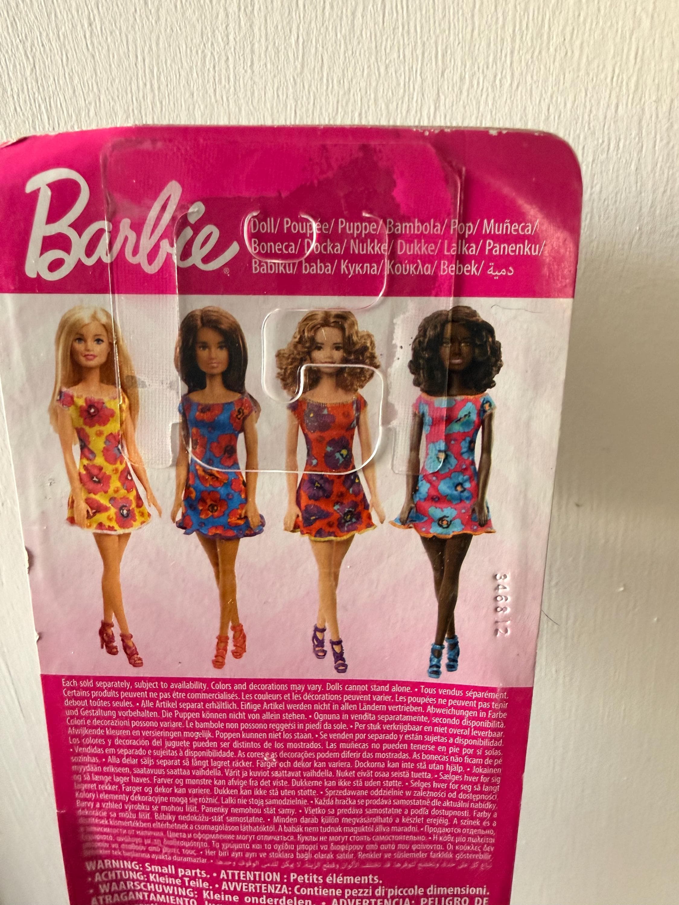 NIB Black Matel Barbie Doll with Floral Dress