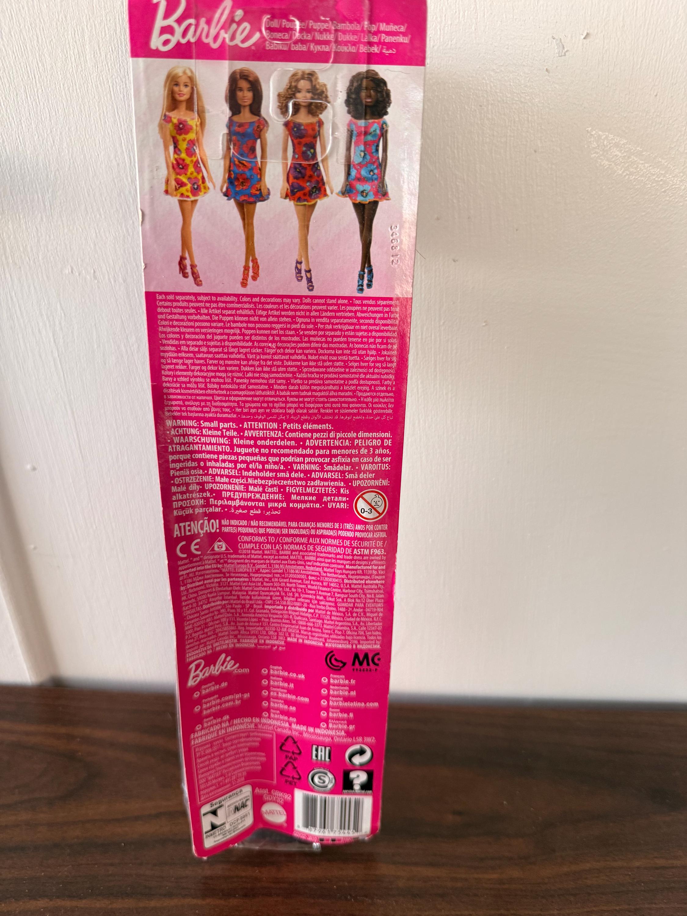 NIB Black Matel Barbie Doll with Floral Dress